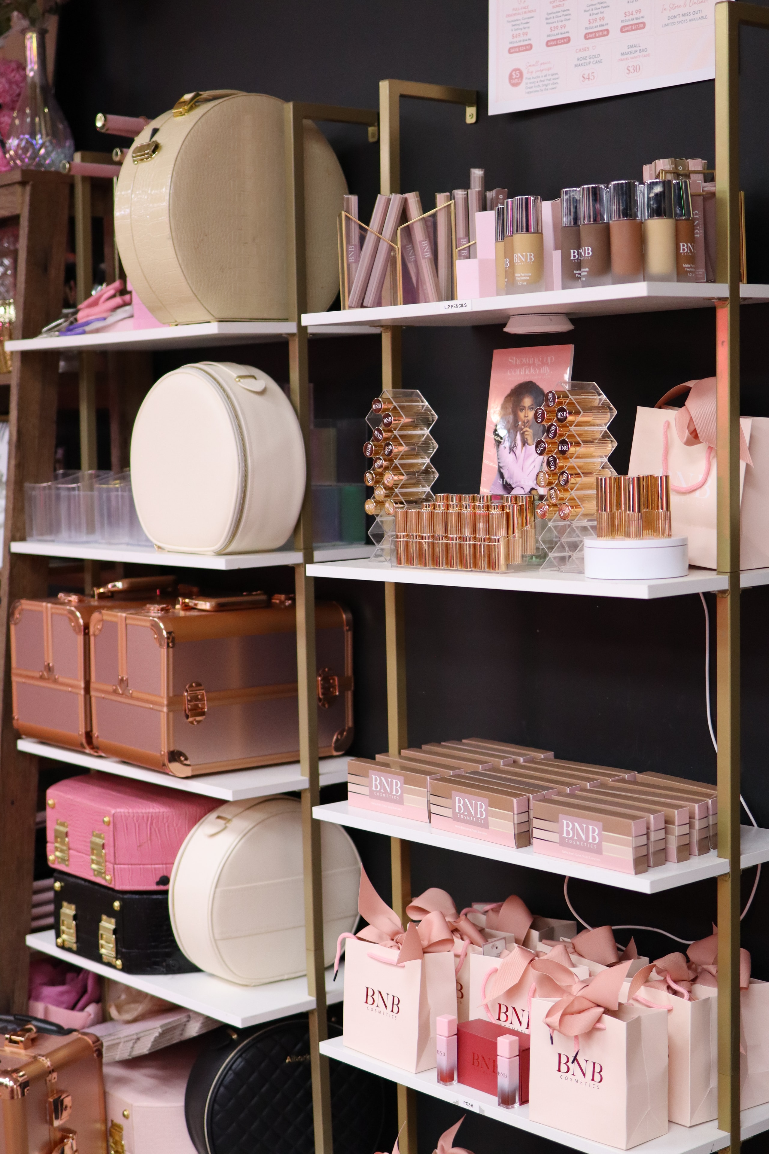 BNB Cosmetics product display shelf with makeup cases and gift sets at event