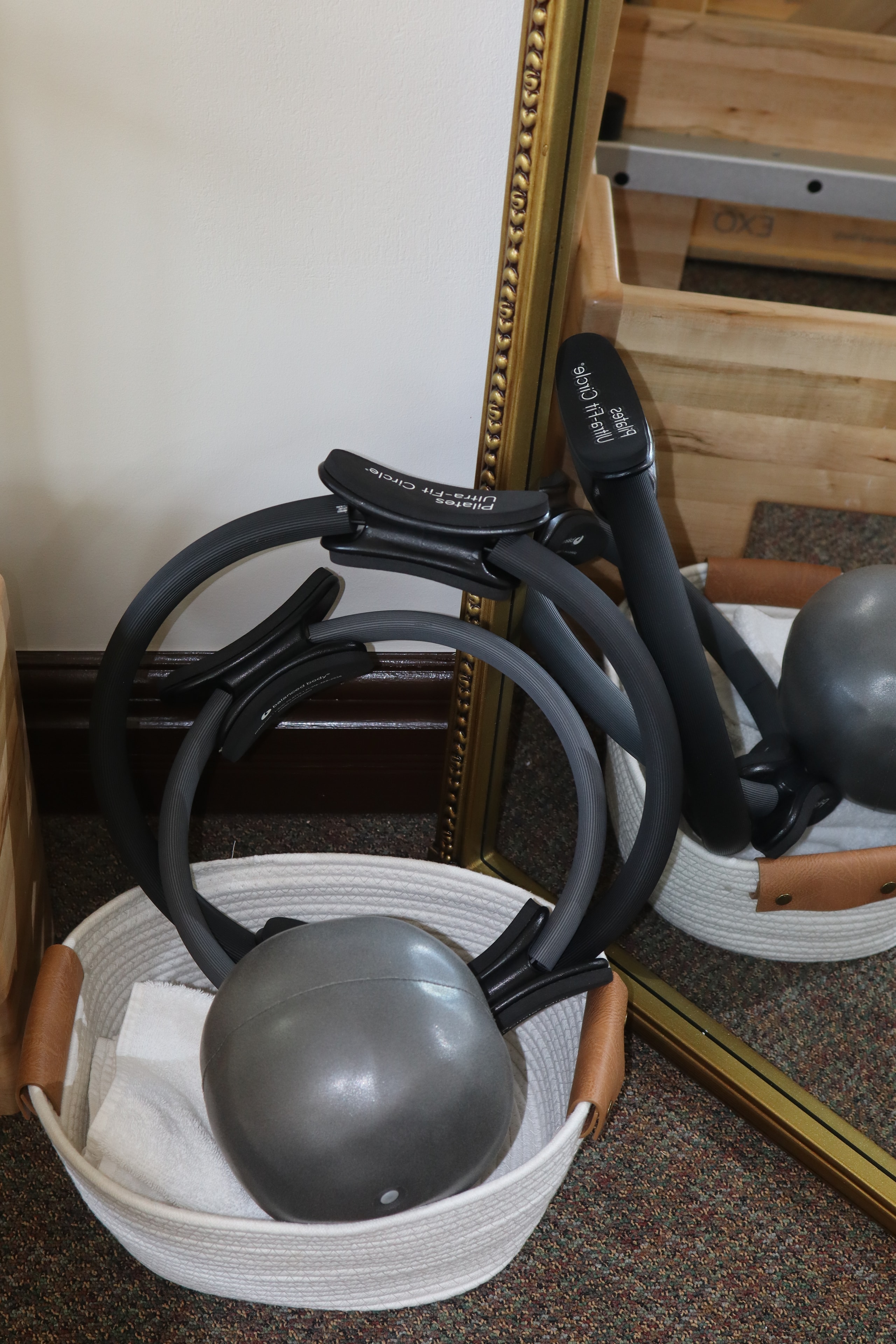 Pilates rings and exercise ball with gold mirror in Wise Body Solutions studio