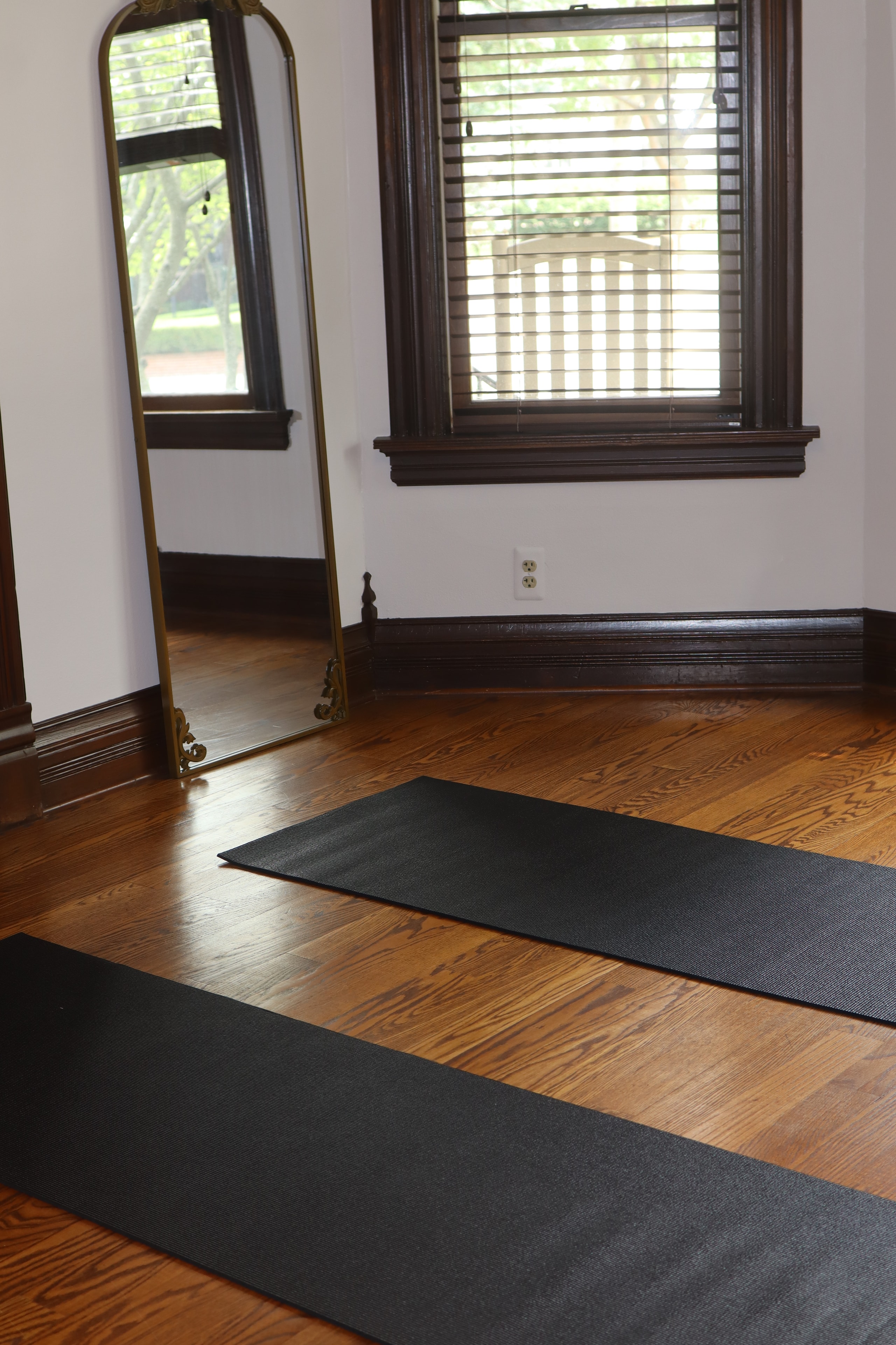 Yoga mats laid out on hardwood floor in Wise Body Solutions studio
